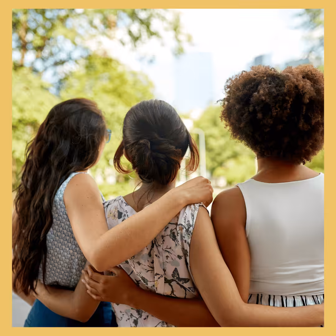 Three women interlocking arms.