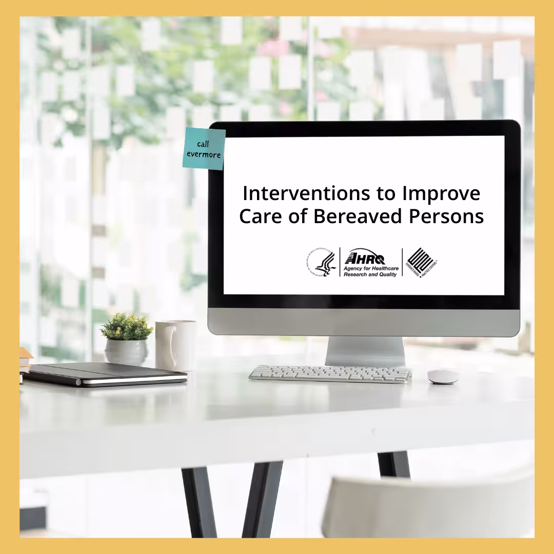Top of a desk with a computer displaying, "Interventions to Improve the Care of Bereaved Persons."